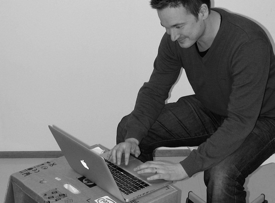 2010 Ilkka sitting at his cardboard desk at the Espoo office 2010 Ilkka sitting at his cardboard desk at the Espoo office